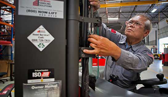 Forklift technician performs quality inspection on lift truck